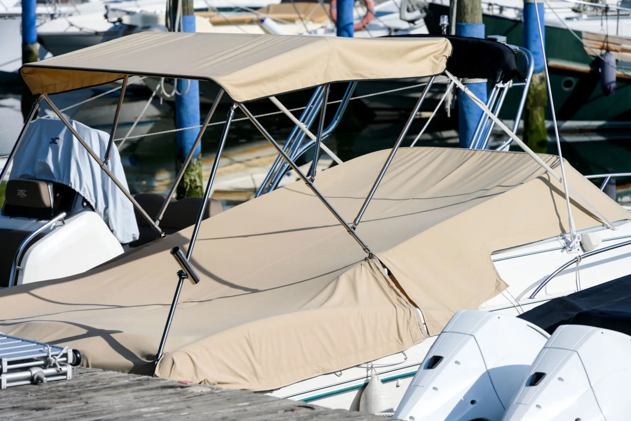 Boat with beige canopy at dock